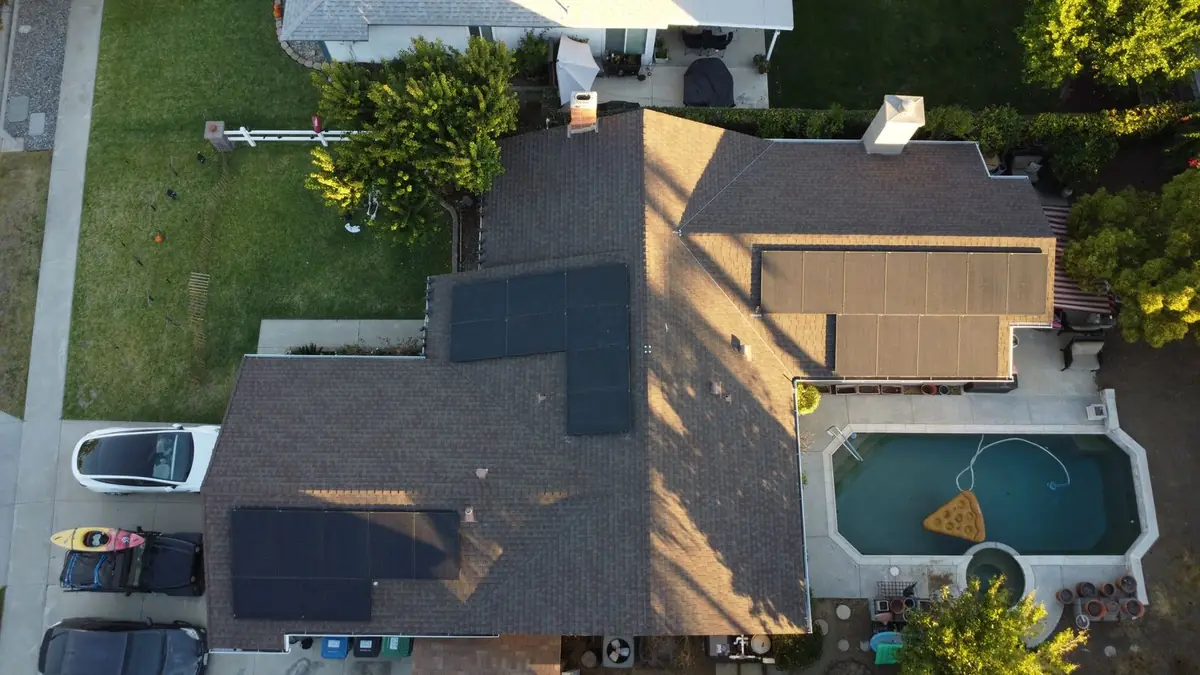 Aerial view of solar panels on a brown shingle roof