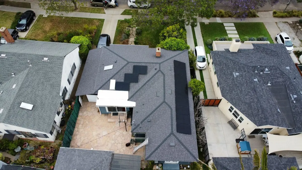 Aerial view of solar panels on a gray shingle roof