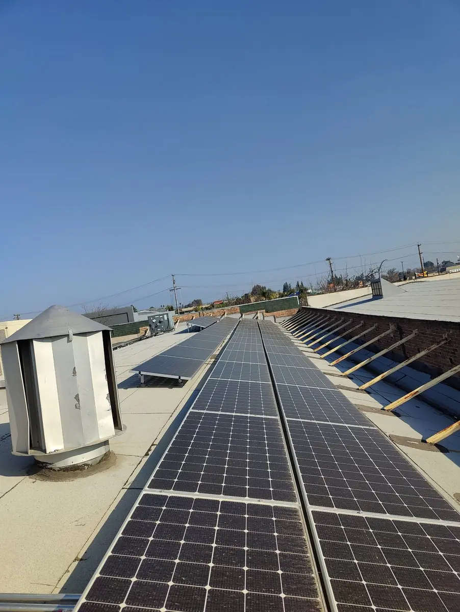 Long rows of solar panels on a commercial roof