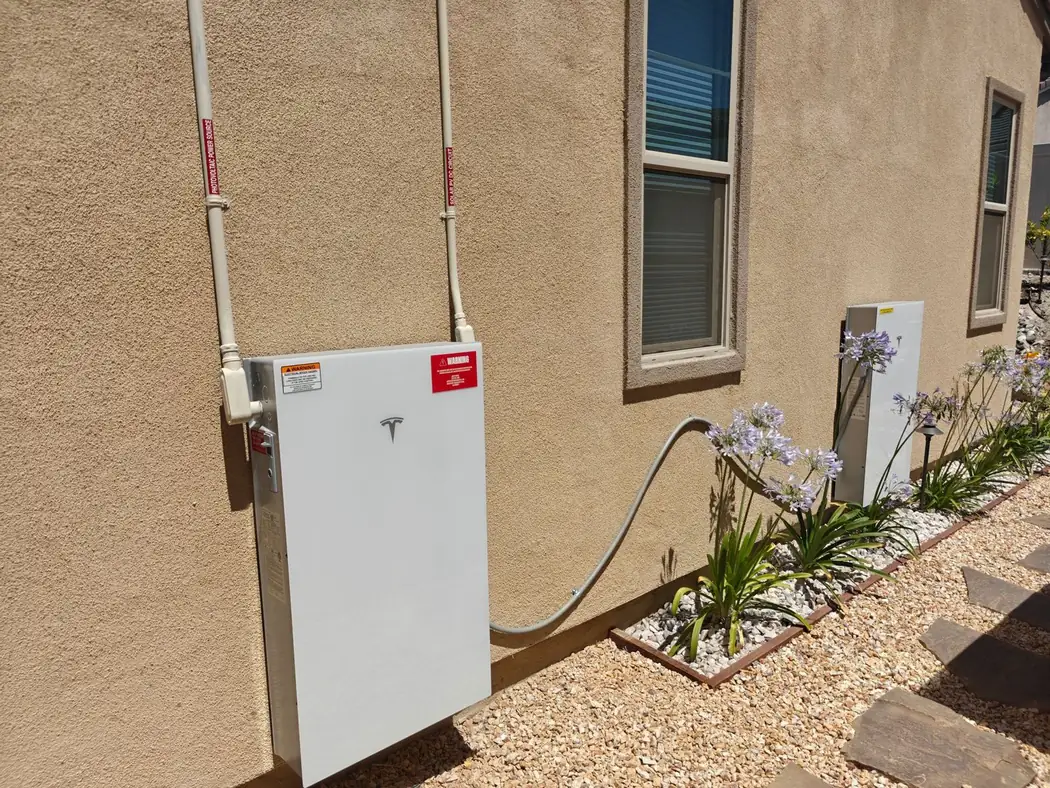 Tesla Powerwall battery mounted on an exterior wall